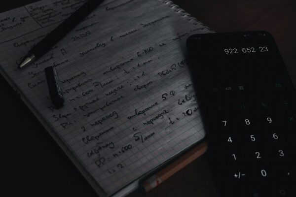 Minimal illustration of a calculator, checklist, and planner representing a debt consolidation plan
